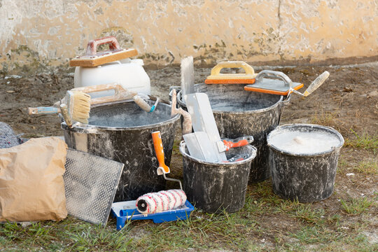 Home renovation with building materials, plaster, paint, and tools for interior construction and finishing work. Concept: high prices for construction work and finishing materials.