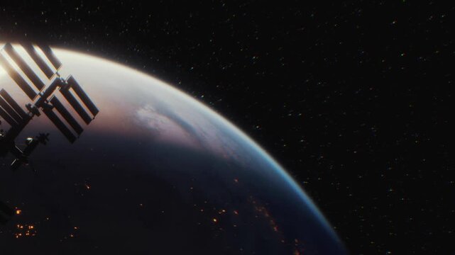 A space station is shown in orbit above Earth. The planet is mostly dark, with small lights from cities shining bright. Stars fill the background, creating a vast view of outer space.