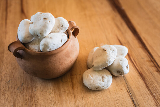 Andean white chu&ntilde;o in an ancestral ceramic pot and plate on a wooden table, raw organic chu&ntilde;os for a healthy vegetarian kitchen and natural nutrition.