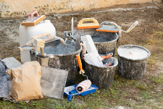 Home renovation with building materials, plaster, paint, and tools for interior construction and finishing work. Concept: providing construction, repair, and finishing services.