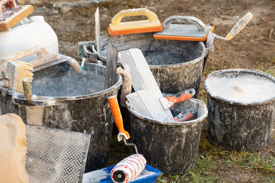 Home renovation with building materials, plaster, paint, and tools for interior construction and finishing work. Concept: providing construction, repair, and finishing services.