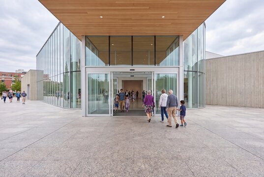 Modern museum entrance building architecture with visitors walking in