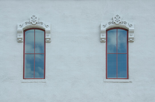 Antique Windows on a Stucco Building