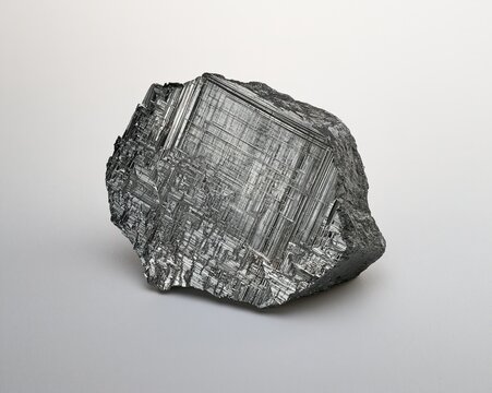 Granular, metallic rock with intricate grid-like patterns.