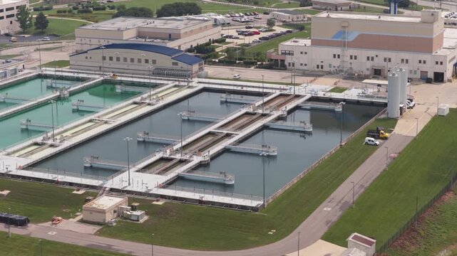Drone landscape of water treatment plant full of drinking liquids and facilities to filter, process, and improve quality of water and building pool space to remove contamination from rivers in America