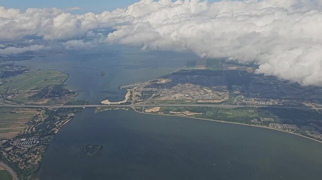 aerial view of amsterdam from the plane entry to the airport with a bridge in the distance