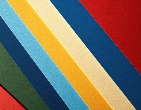 Diagonal rows of textured paper in vibrant red, dark blue, light blue, yellow, cream, and green