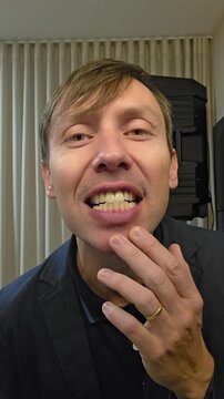 homem exibindo os dentes para c&acirc;mera 