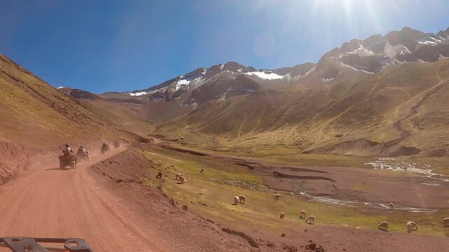 ATV quad bikes riding through the spectacular Andes mountains near Cusco, Peru