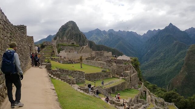 Tourists hiking near the ancient Inca citadel in the Andes