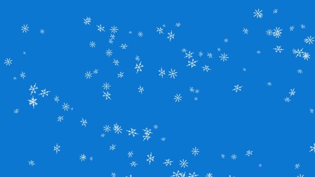 Close-up of falling snowflakes on blue background for winter themes