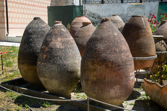 Ancient clay wine vessels on a sunny day. Old technologies. World tourism.
