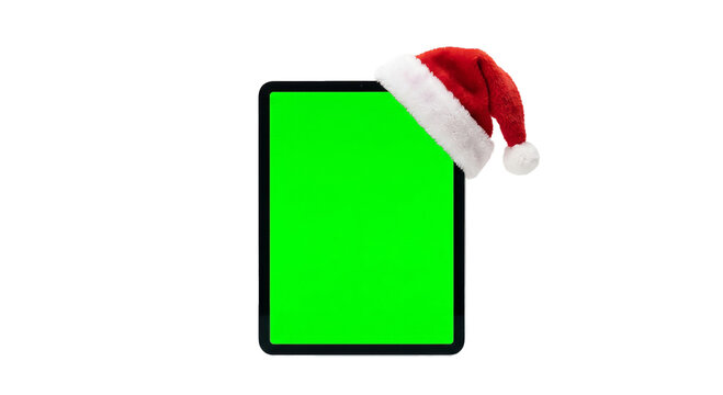 Tablet with green screen wearing a festive Santa hat for holiday promotions