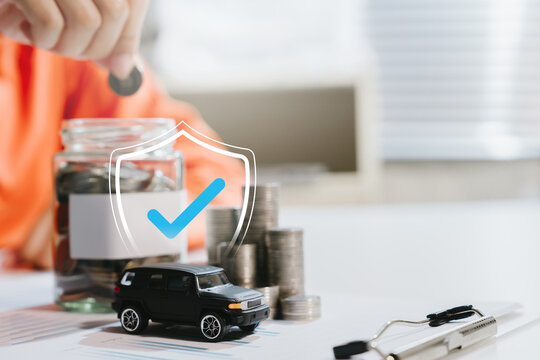 Car insurance concept. Vehicle beside savings jar and coins with protection shield representing coverage, finance, safety, security, risk management.