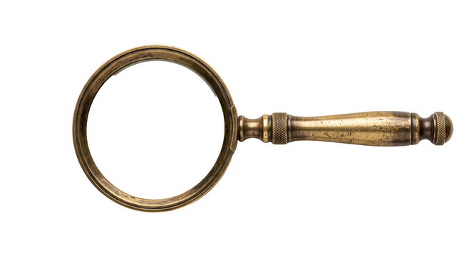 Antique brass magnifying glass with detailed handle and frame, isolated on white