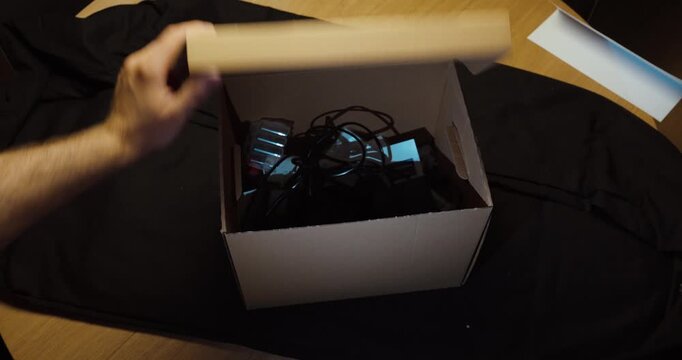 Person ignores a Top Secret warning and searches inside a confidential box. Ideal for unauthorized access, security breach, espionage and data theft.