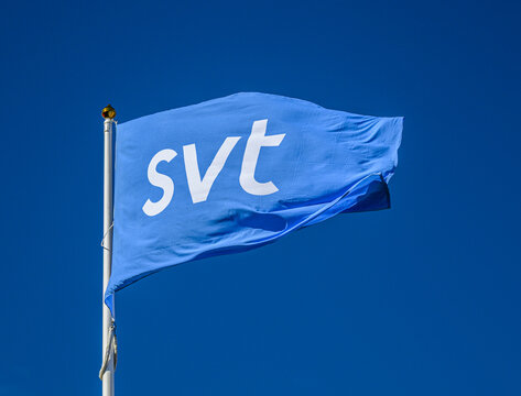 Gothenburg, Sweden - June 23 2026: Blue transit service flag waving against clear summer sky.