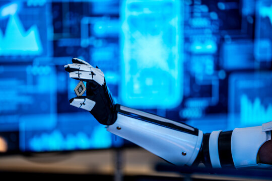 Black female technology specialist with a bionic prosthetic arm works alongside a South Asian male developer in a dark AI laboratory.