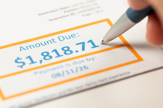 A utility bill displaying the amount due and payment deadline with a pen, illustrating household expenses, budgeting, medical bill payments, personal finance and financial planning.