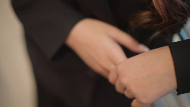 Tight close-up of two clasped hands with interlaced fingers, showing slight fingertip movement, soft blur, warm light, and calm intimate mood with visible tension and quiet reflection