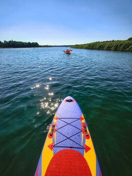 Stand up paddle board on a sunny lake in Poland