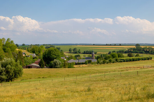 Summer landscape, The terrain of hilly countryside, A hamlet on hillside with green grass meadow and tree, Eys is a village in the municipality of Gulpen-Wittem and region in Zuid-Limburg, Netherlands