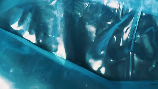 Abstract glossy blue plastic film texture background wrap material surface