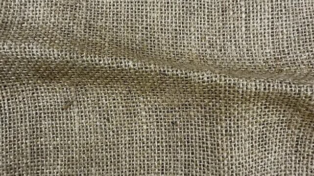 Textured burlap cloth background with woven natural jute fibers, rough brown fabric pattern