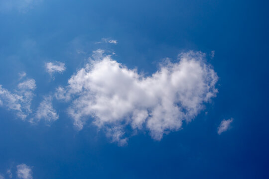 Beautiful white fluffy cloud floating in blue sky in sunny day, Cumulus are clouds which have flat bases and are often described as puffy, Horizon nature background with free copy space.