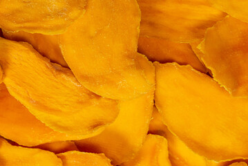 Fototapeta premium Dry tasty mango slices isolated on a white background.