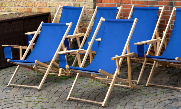 Blue Deck Chairs on a Cobblestone Courtyard