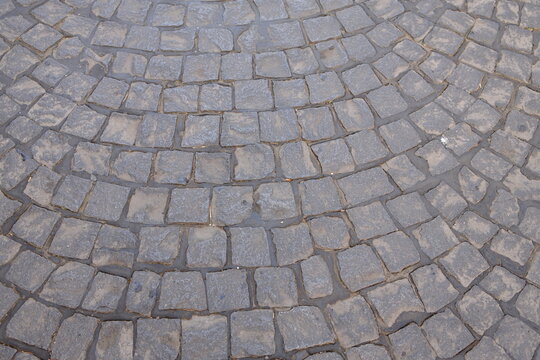 Square stone road paving pattern close up top view. Geometric pavement texture made of square paving stones, top view