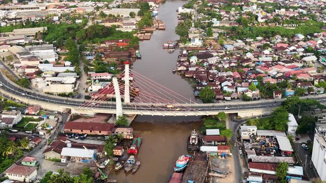 Aerial view of Banjarmasin city and the Alalak River Bridge (or Basit Handil Bakti Bridge) in the late afternoon