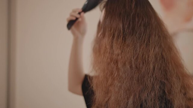 Rear and chest-up views show person grooming very long thick beard with paddle brush in warm indoor setting, visible downward brushing strokes, backward passes toward roots, gentle lifting, smoothing