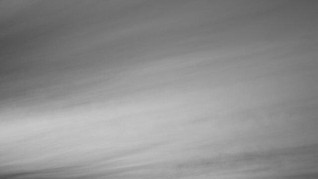 Gray background, gray sky and clouds in the photo in the form of various lines and stripes with gradient transitions