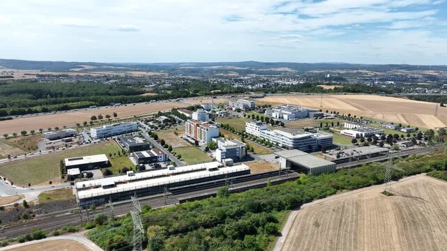 Drone aerial footage of Ice Stadt Limburg an der Lahn business district, Limburg S&uuml;d station and A3 motorway, Germany