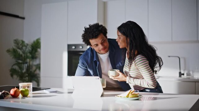 Home lovers talking computer looking tablet screen calm kitchen morning closeup