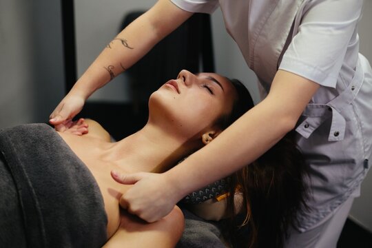 Woman enjoying professional shoulder and neck massage