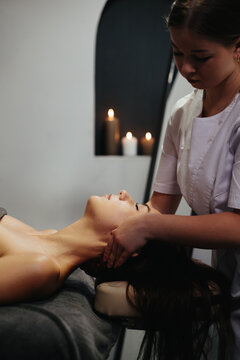 Woman enjoying neck massage in relaxing spa environment