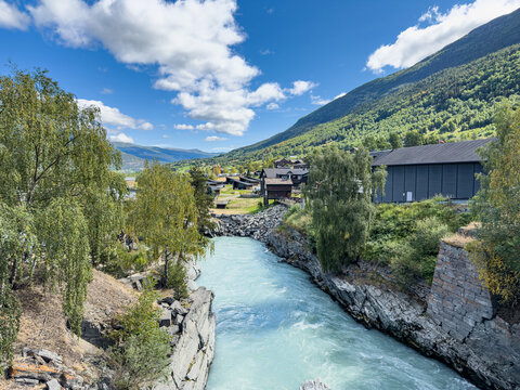 Turquoise Bovra river running through the village of Lom, Norway