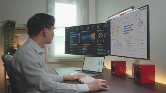 A Man Business financial Focus dashboard database information report on screen monitor.