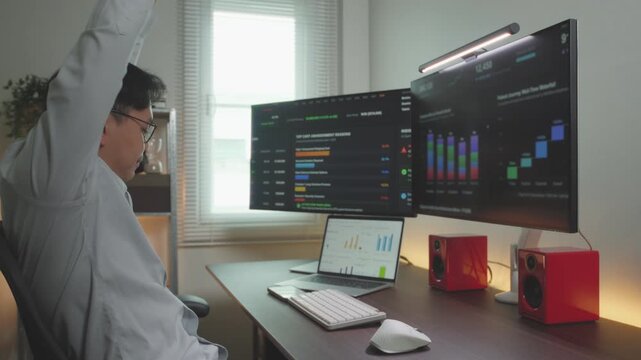 Asia male Financial Business man Stretching after time out database analysis worked.
