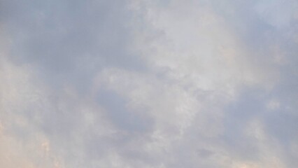 Soft, tranquil clouds drifting across a serene pastel blue sky © DidiVision