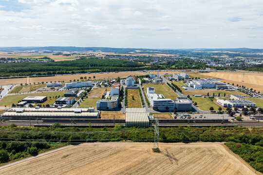 Drone aerial view of Ice Stadt Limburg an der Lahn business district, Limburg S&uuml;d station and A3 motorway, Germany