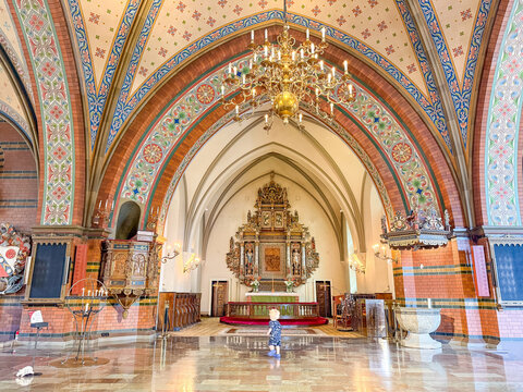 Painted vaults and golden altar inside Trelleborg church