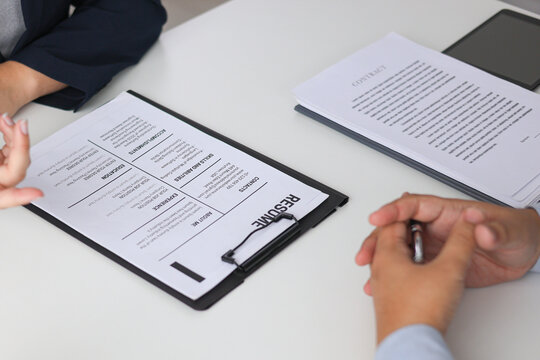 Close-up Of Job Interview and Resume Two Professional Discussing Career Experience and Qualifications.