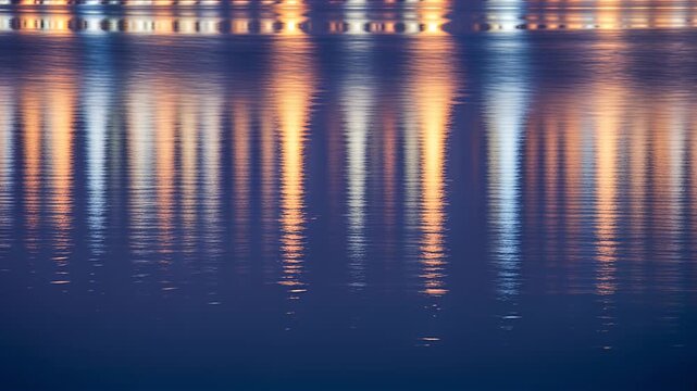 water reflections night city lights on calm water