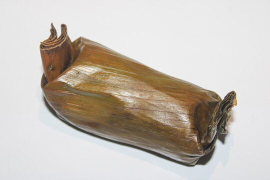 Traditional Indonesian Lemper Wrapped In Banana Leaf On White Background