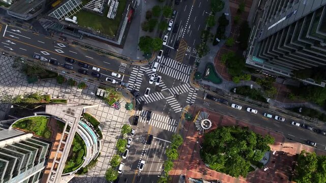 An aerial view of a busy urban road junction in Seoul showing traffic flow, road markings, and surrounding buildings from above.