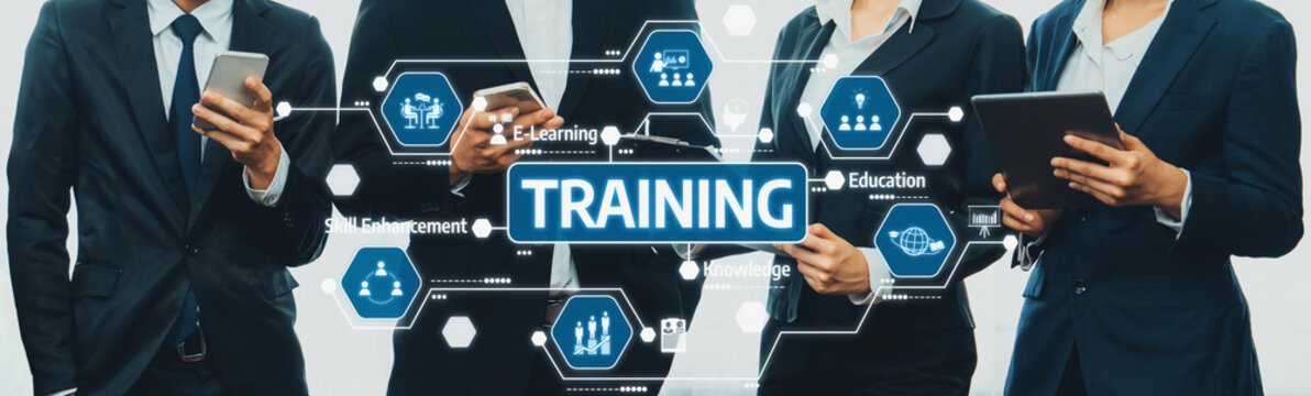 Business professionals collaborate on training strategies using mobile devices and digital tools, highlighting the importance of e-learning in a modern corporate environment. Amity
